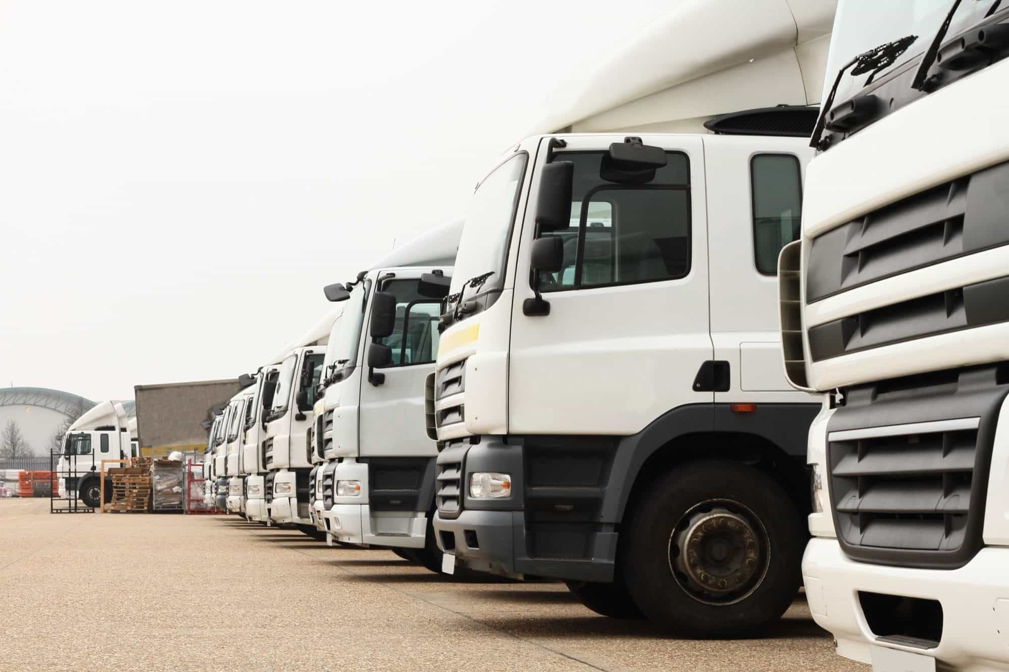A row of lorries lined up at a distribution yard A row of lorries lined up at a distribution yard